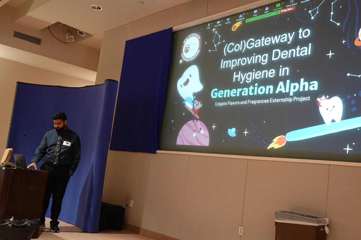 Student standing at podium in front of opening slide