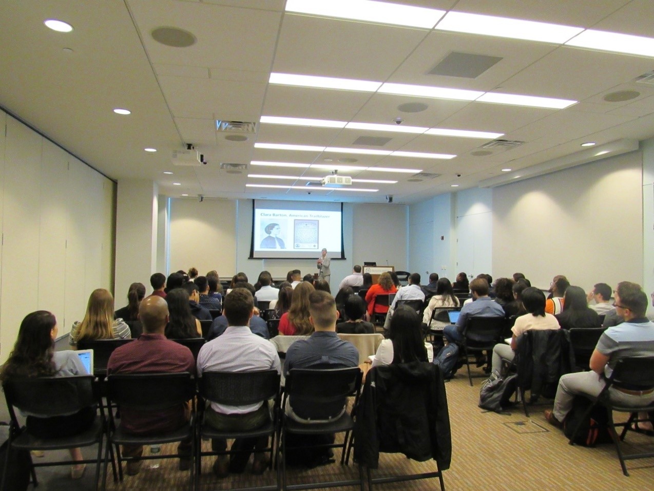 Students in chairs facing presentation