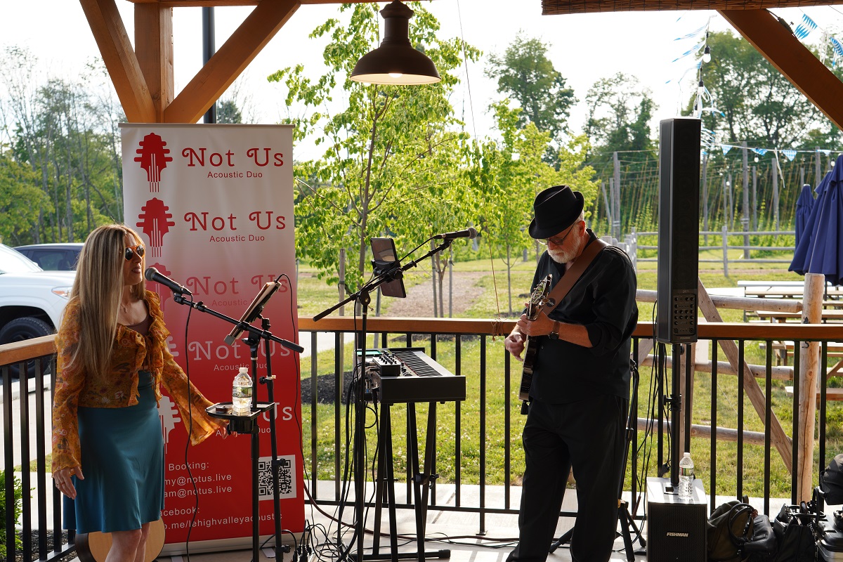 Musical duo performing outdoors.