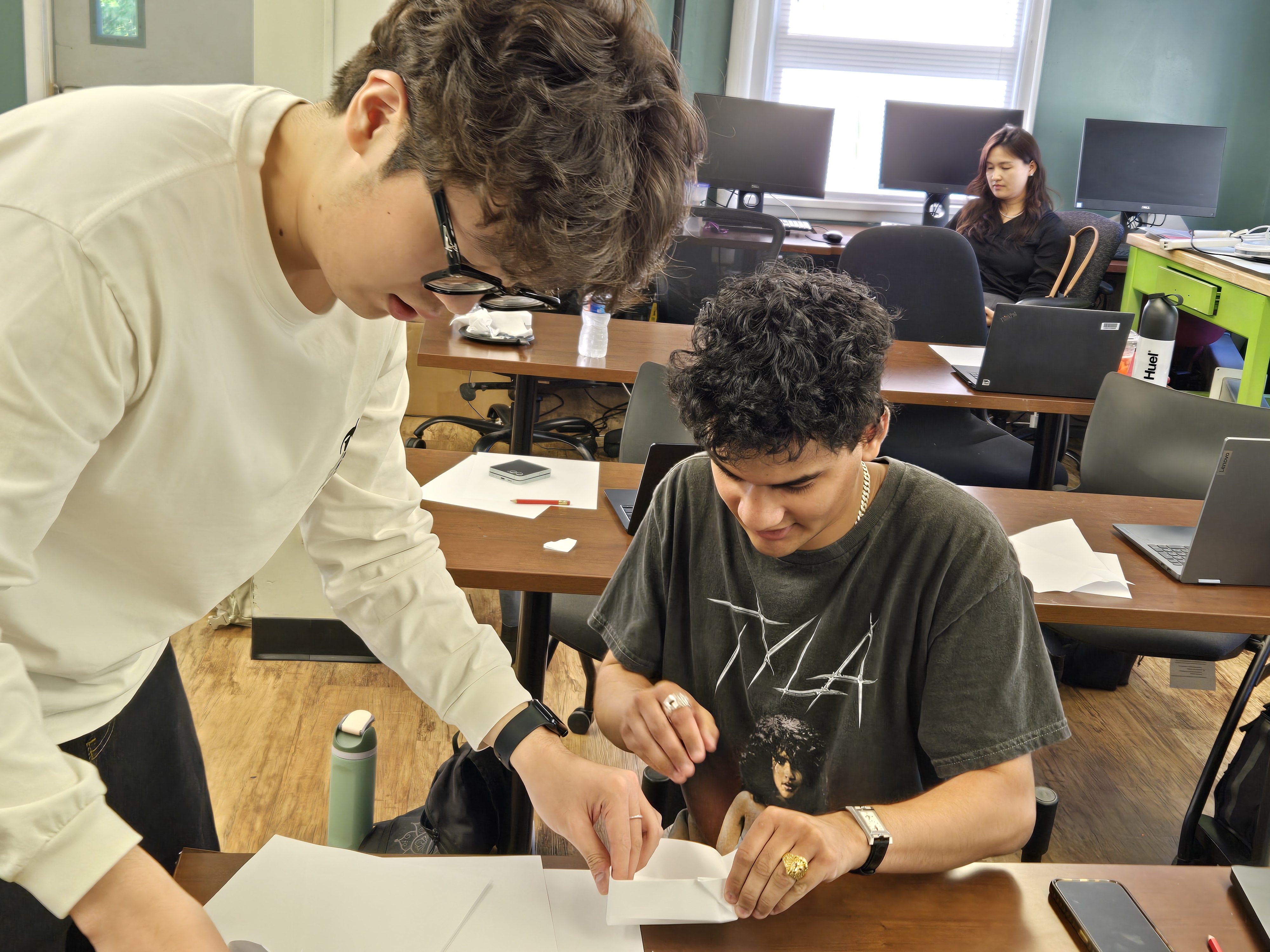Two students helping out each other