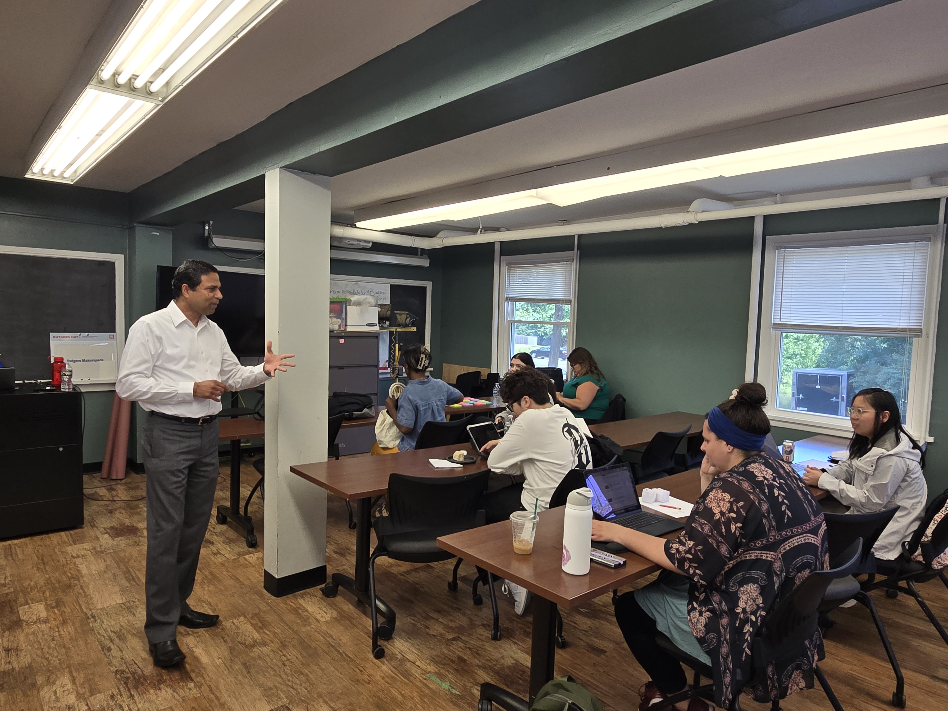 A professor teaching students during a class workshop