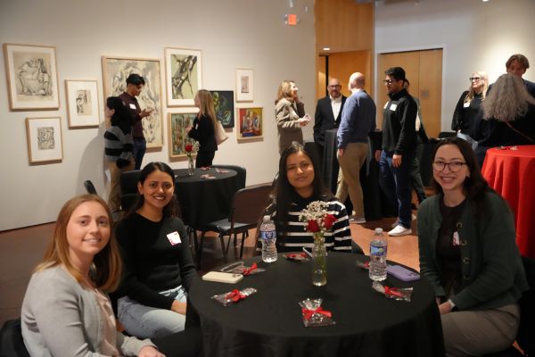 A group of girls at a table having a conversation