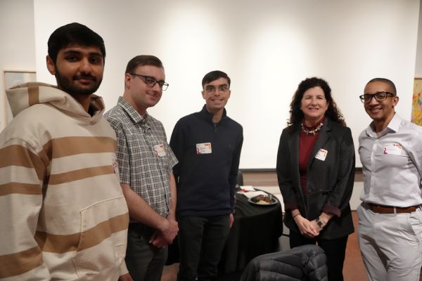 4 students posing with the Director