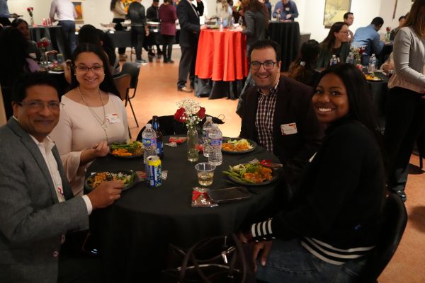 4 people at a table having a conversation