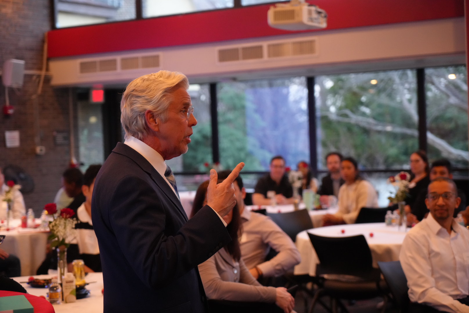 Man in suit addressing room