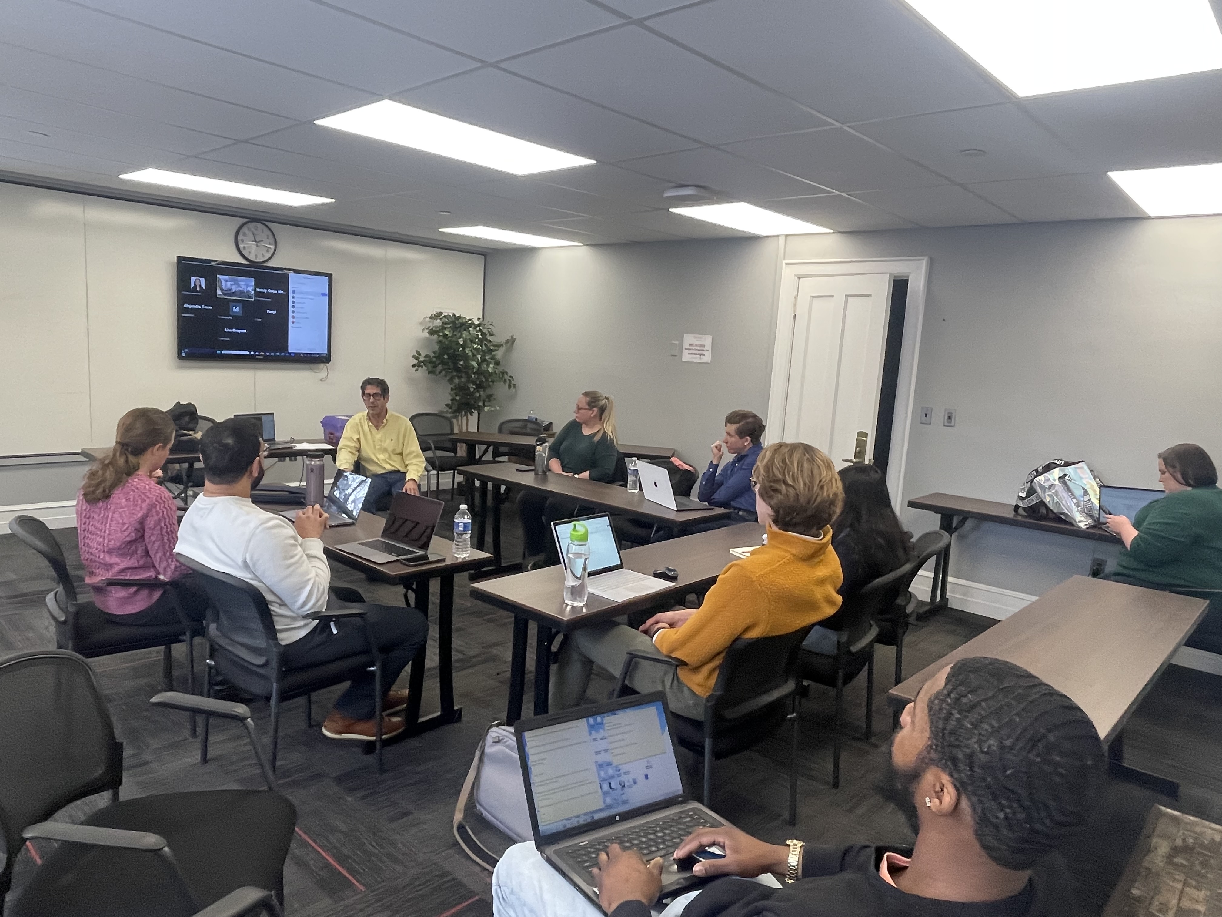 faculty leading workshop surrounded by students