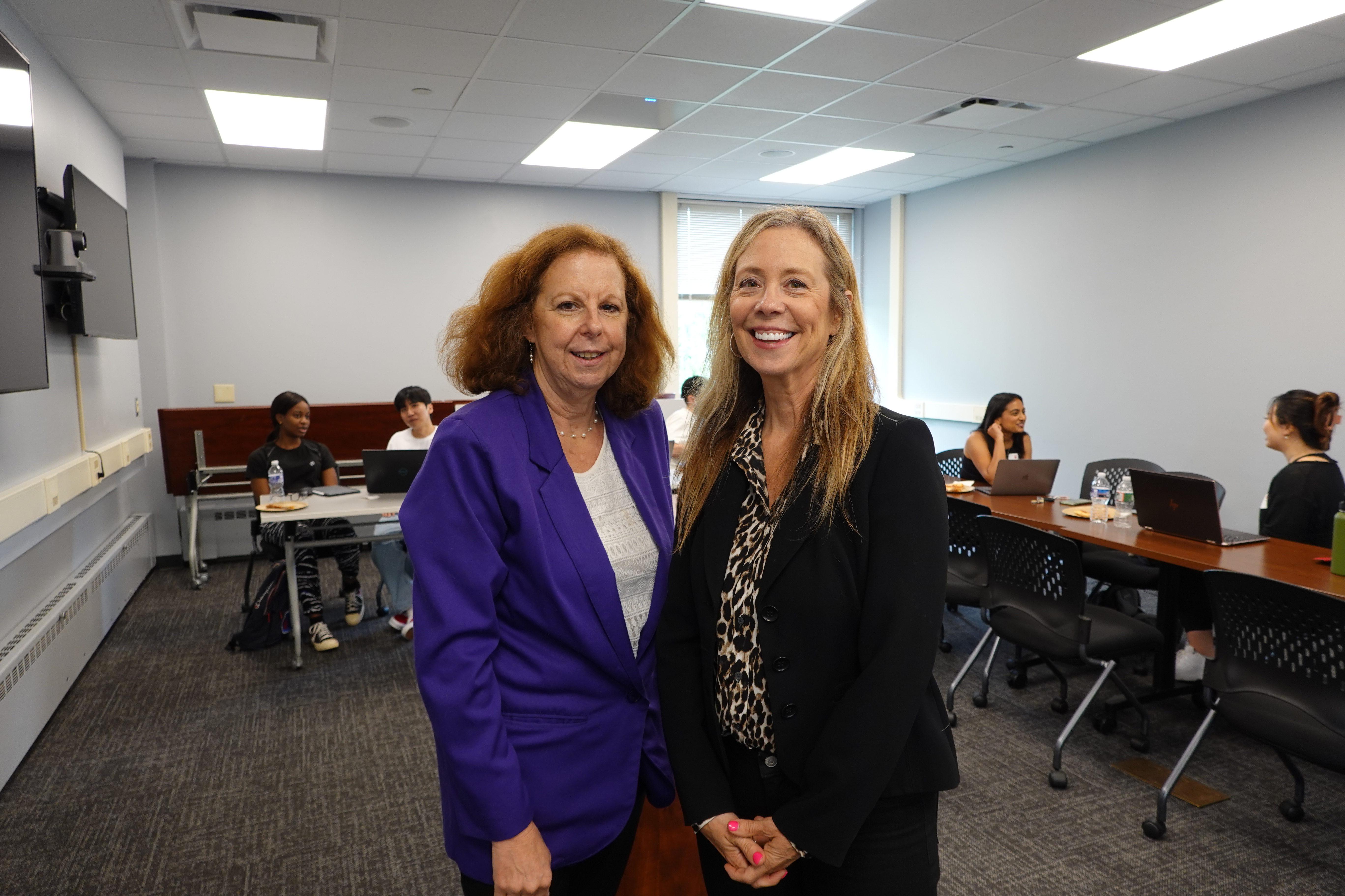 Two MBS faculty members standing together.