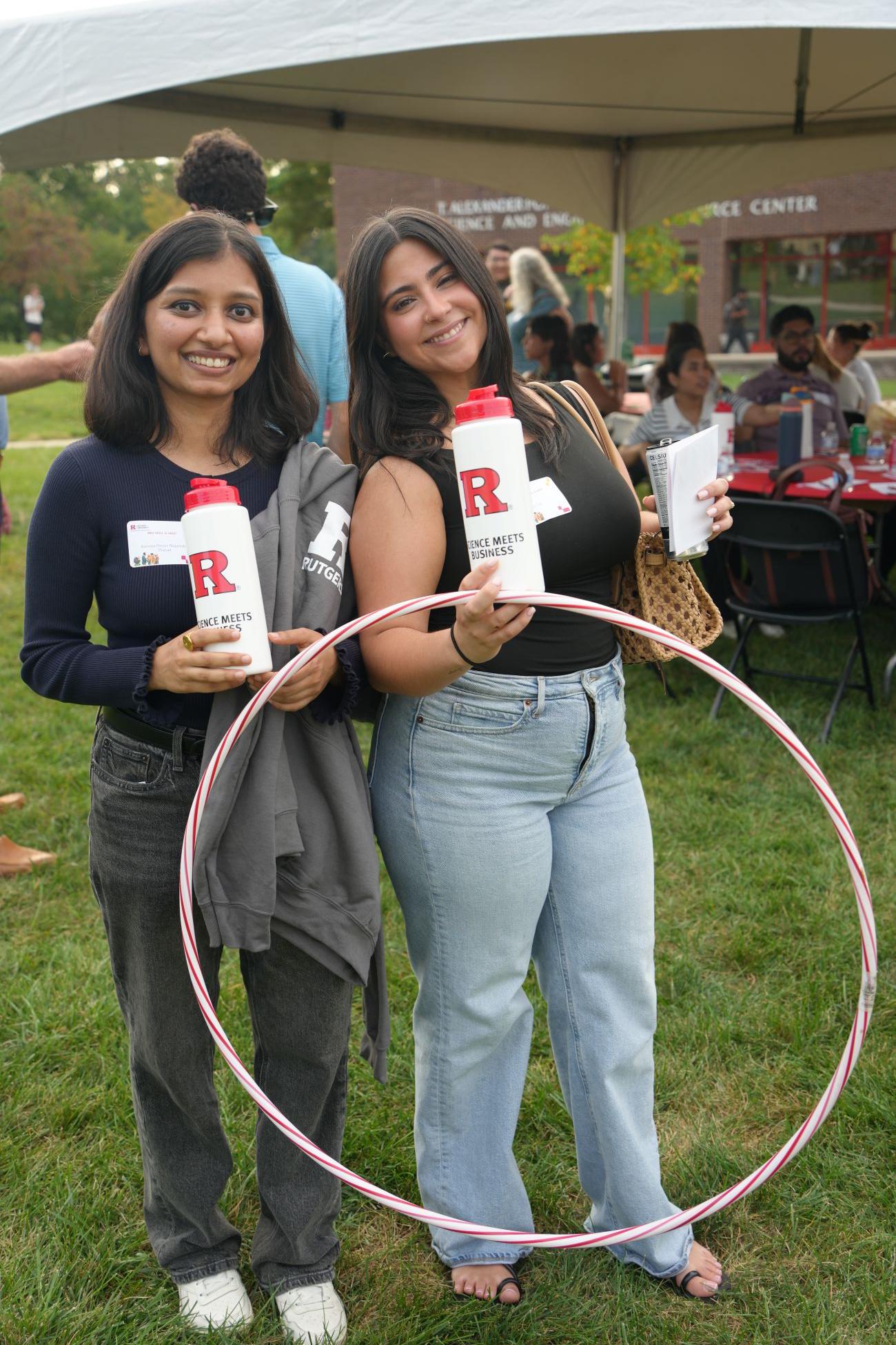 Two girls with water bottles smiling for a picture