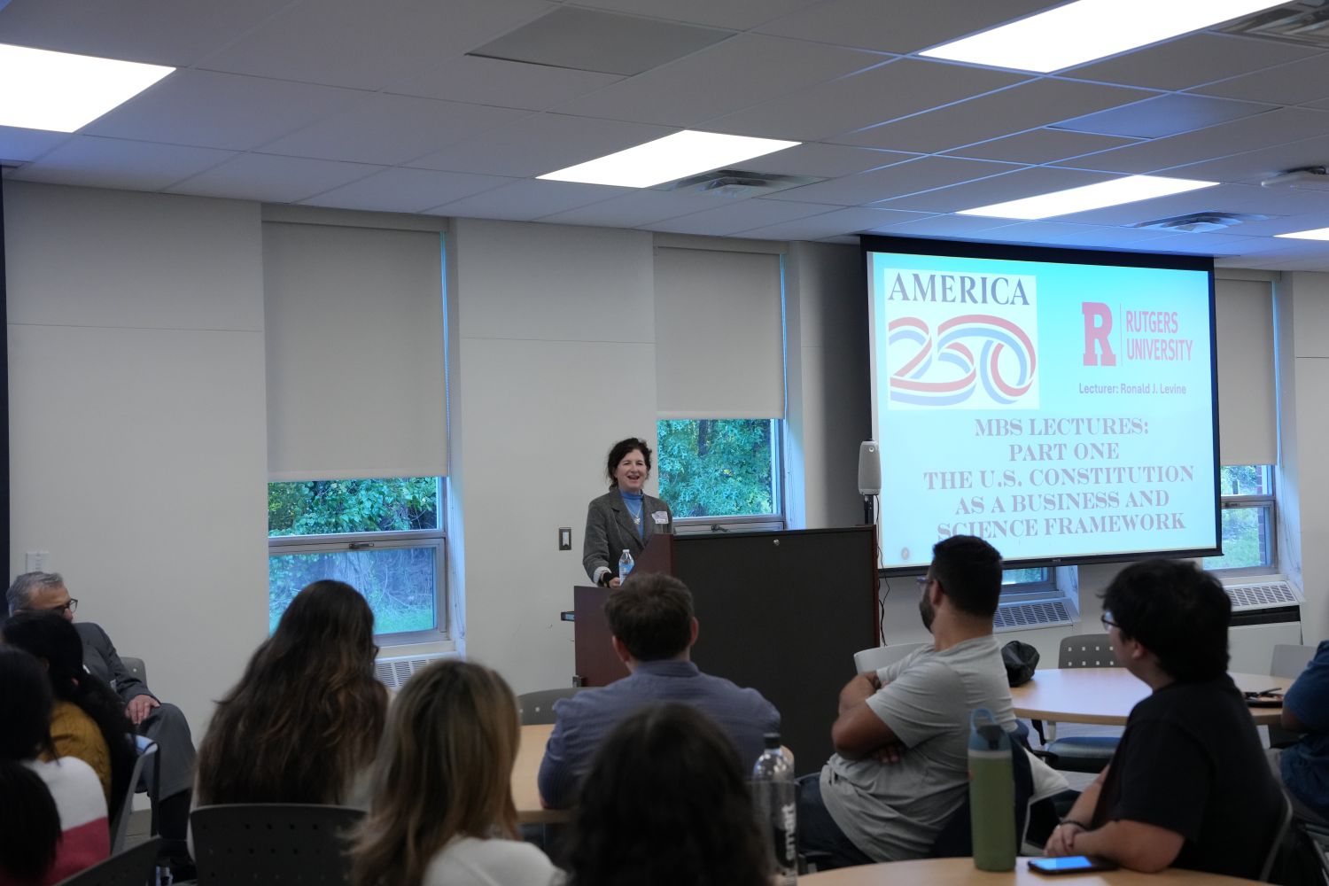 A professor presenting to a class of students