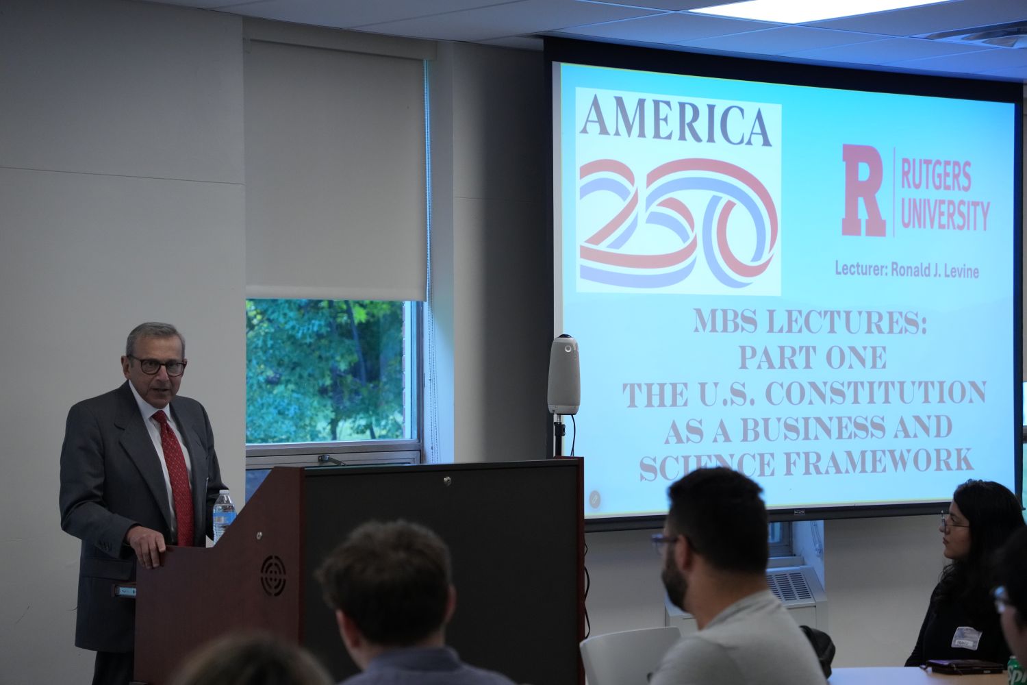 A professor presenting to a class of students