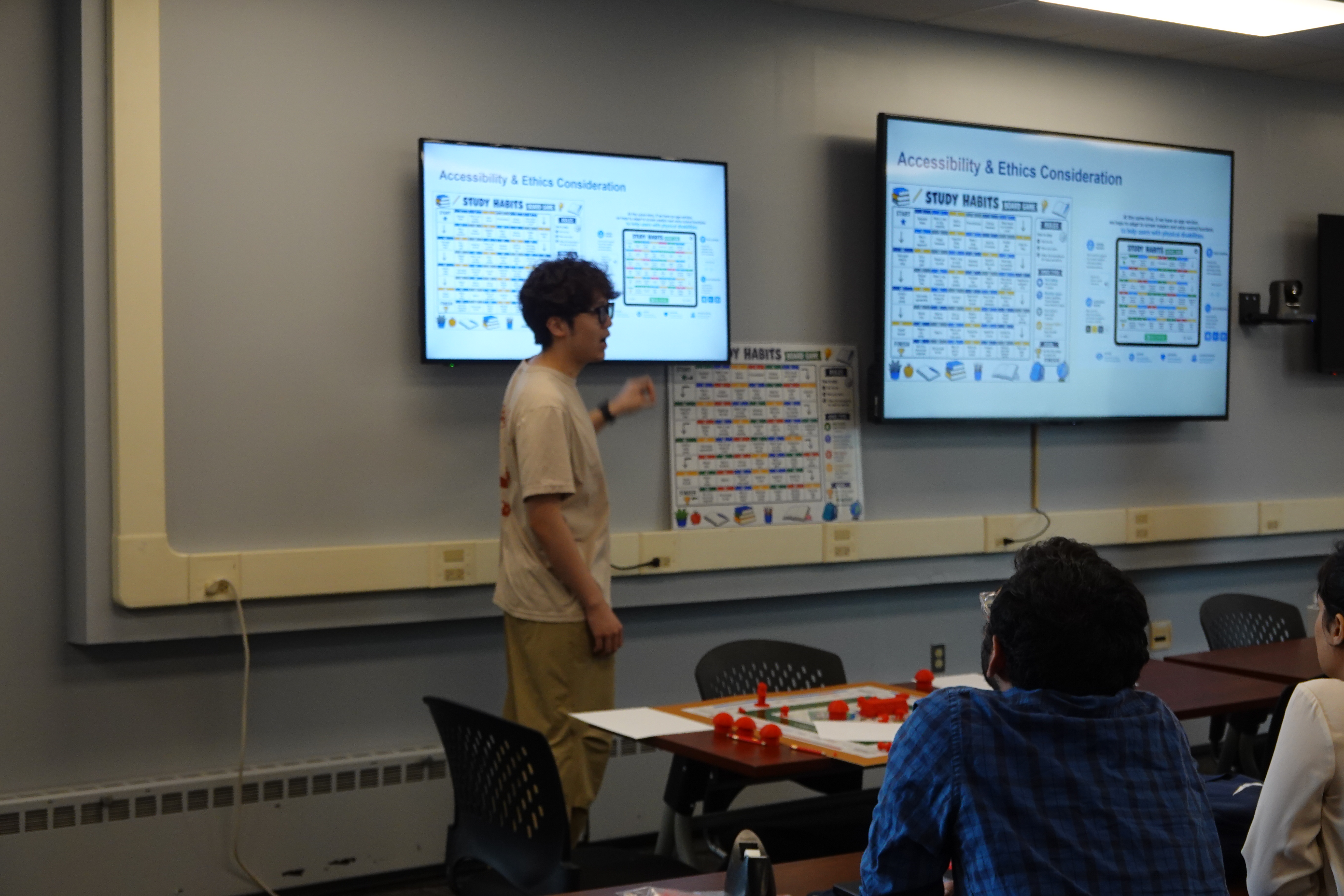 A student presents his work to the rest of his classmates