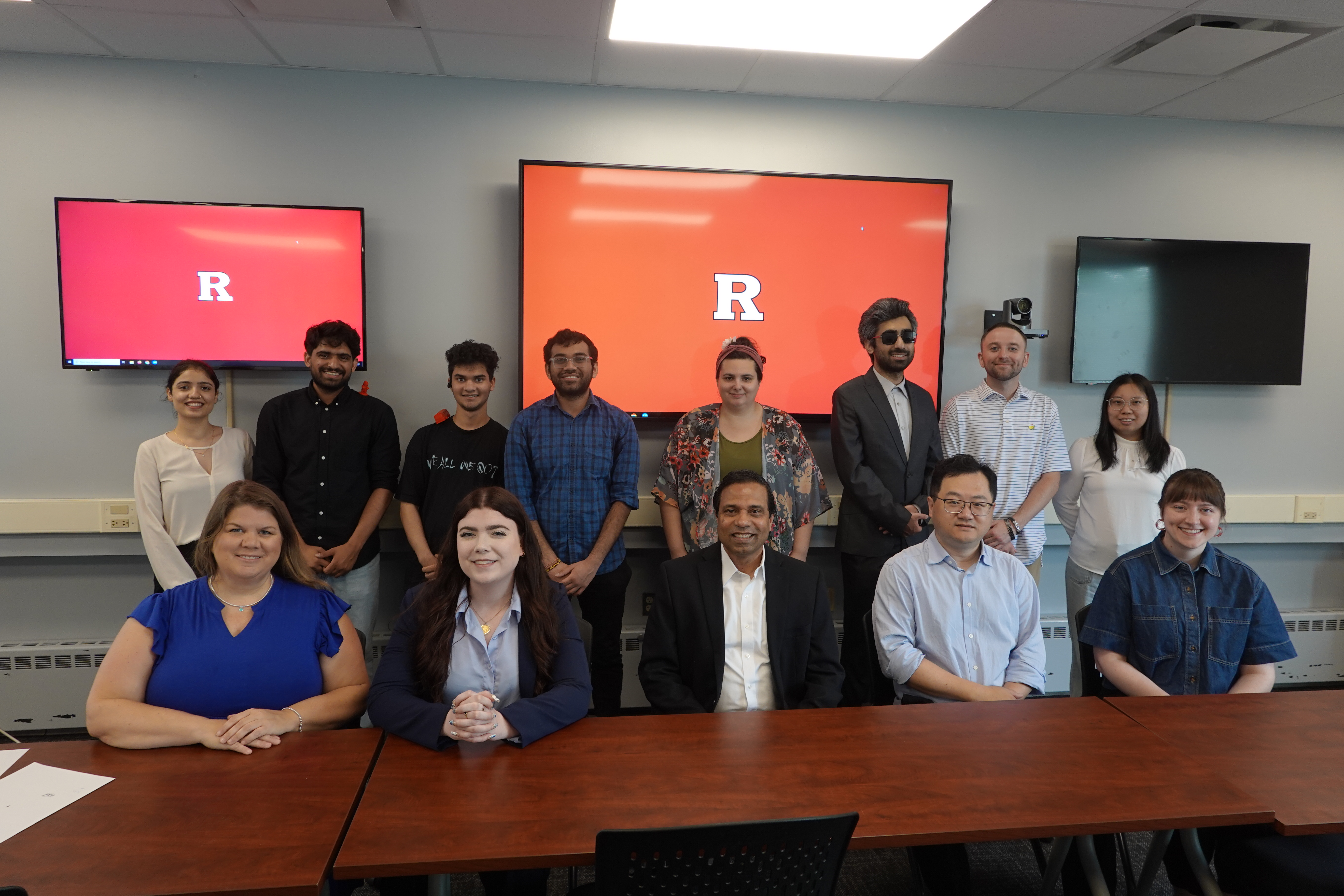 A group of students and faculty smiling for the camera 