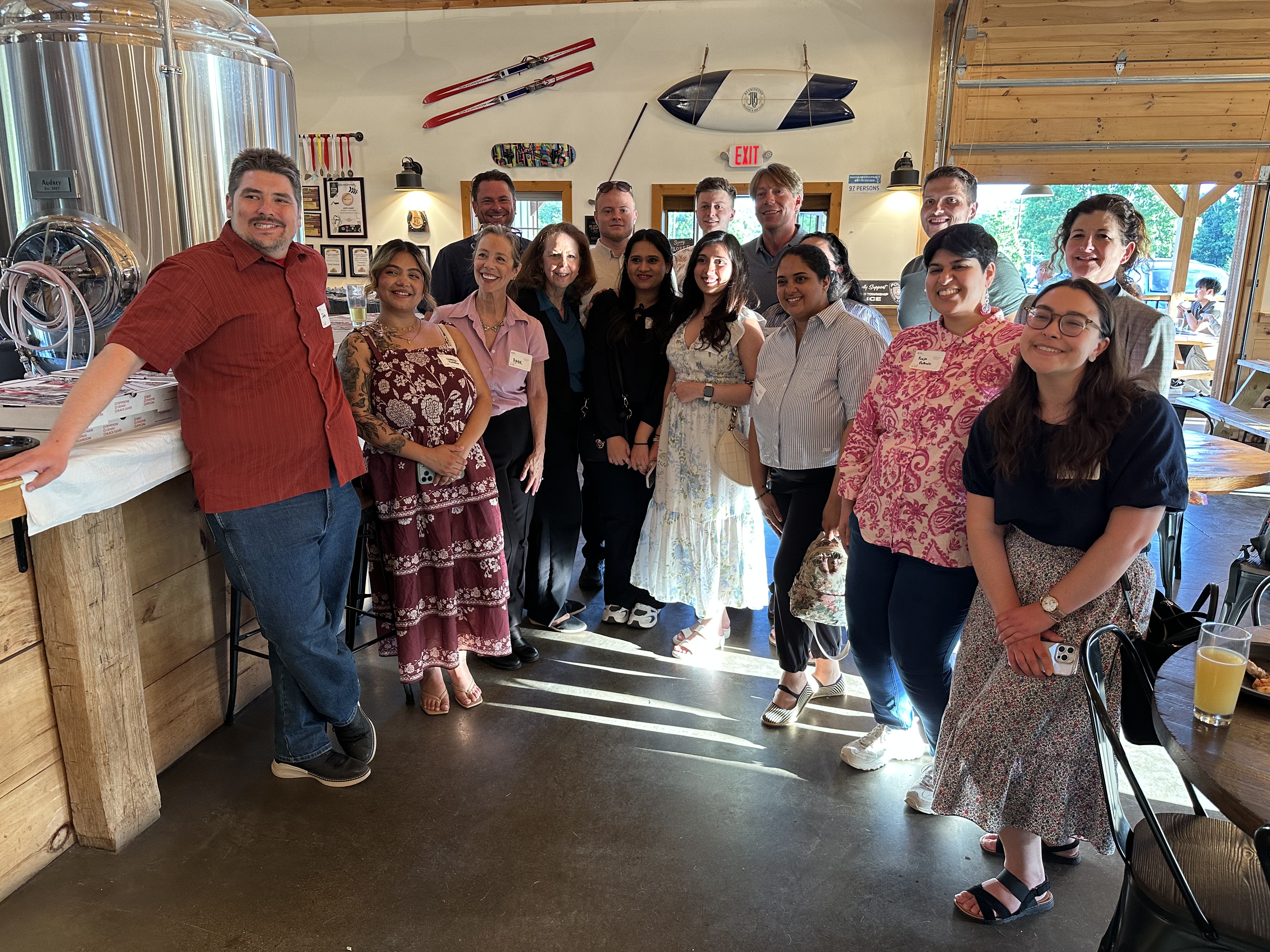 A group of people at a brewery posing for a photo