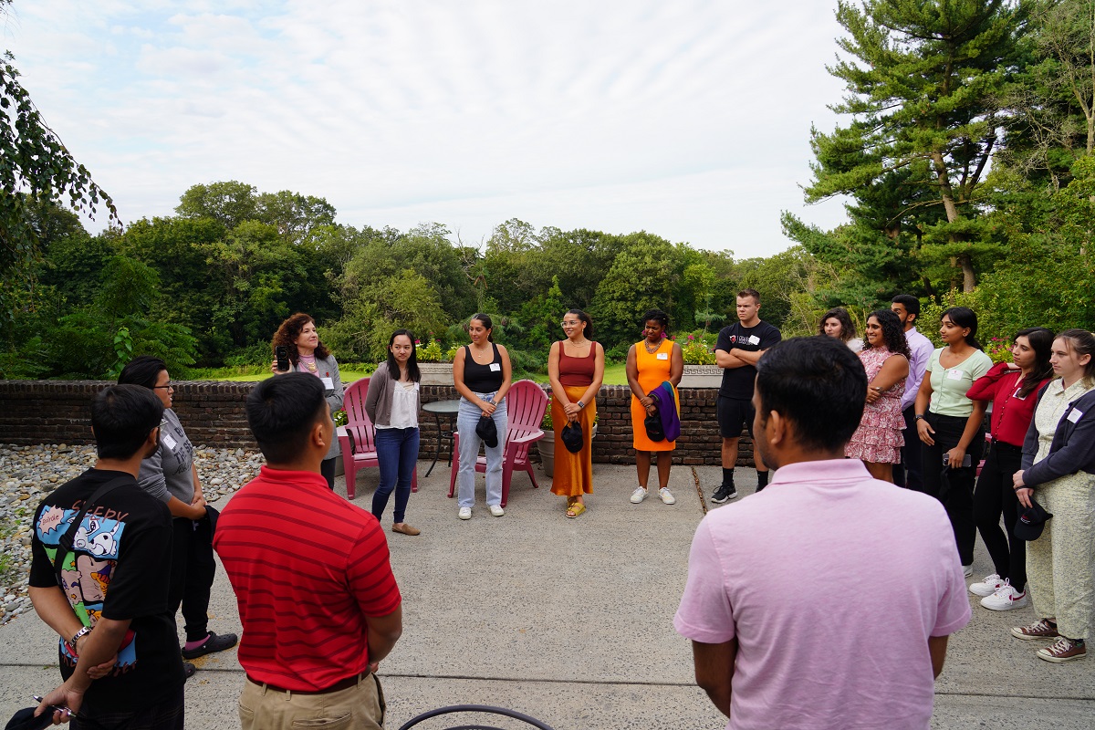 Students standing in a circle outdoors.