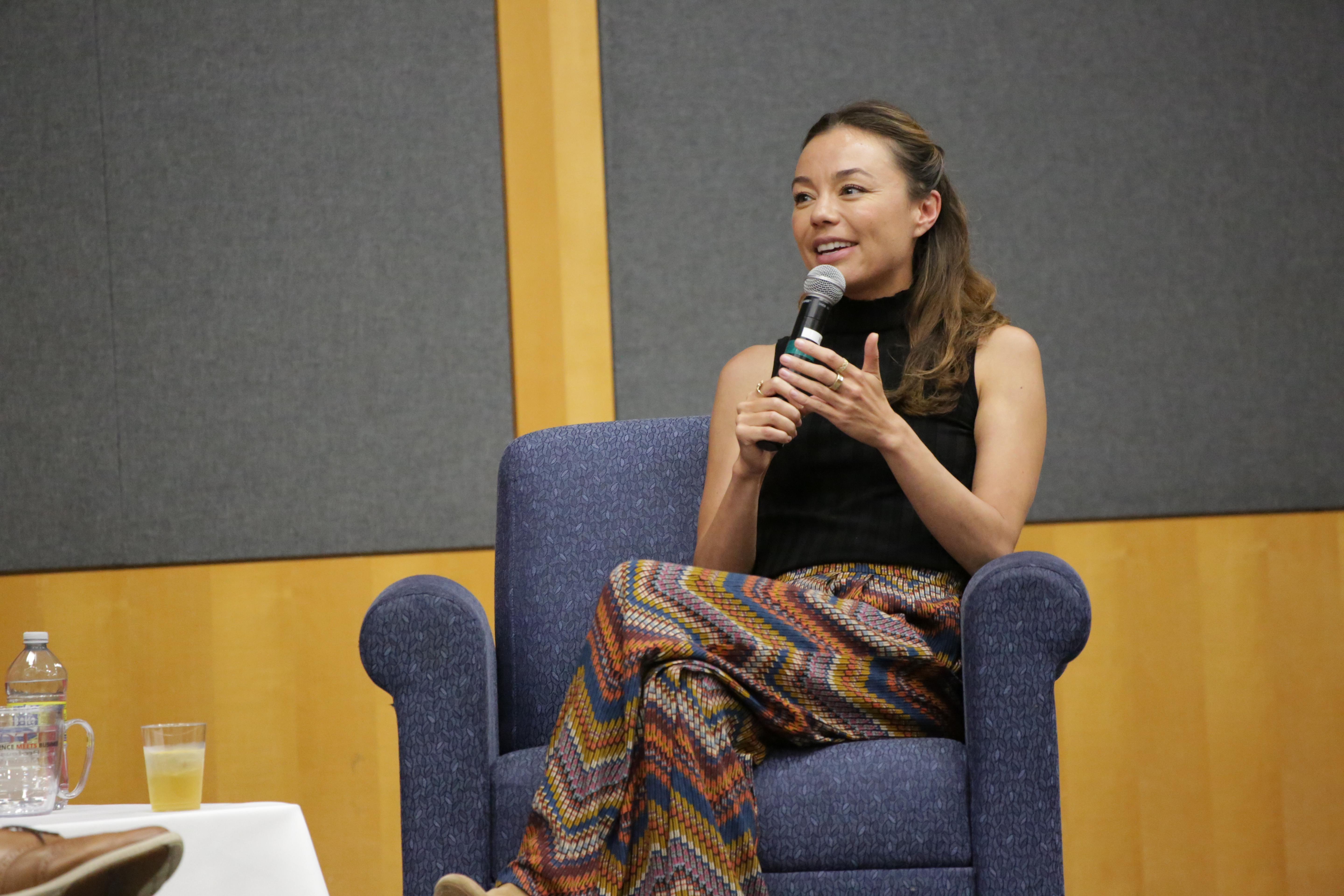 woman sitting in chair with microphone