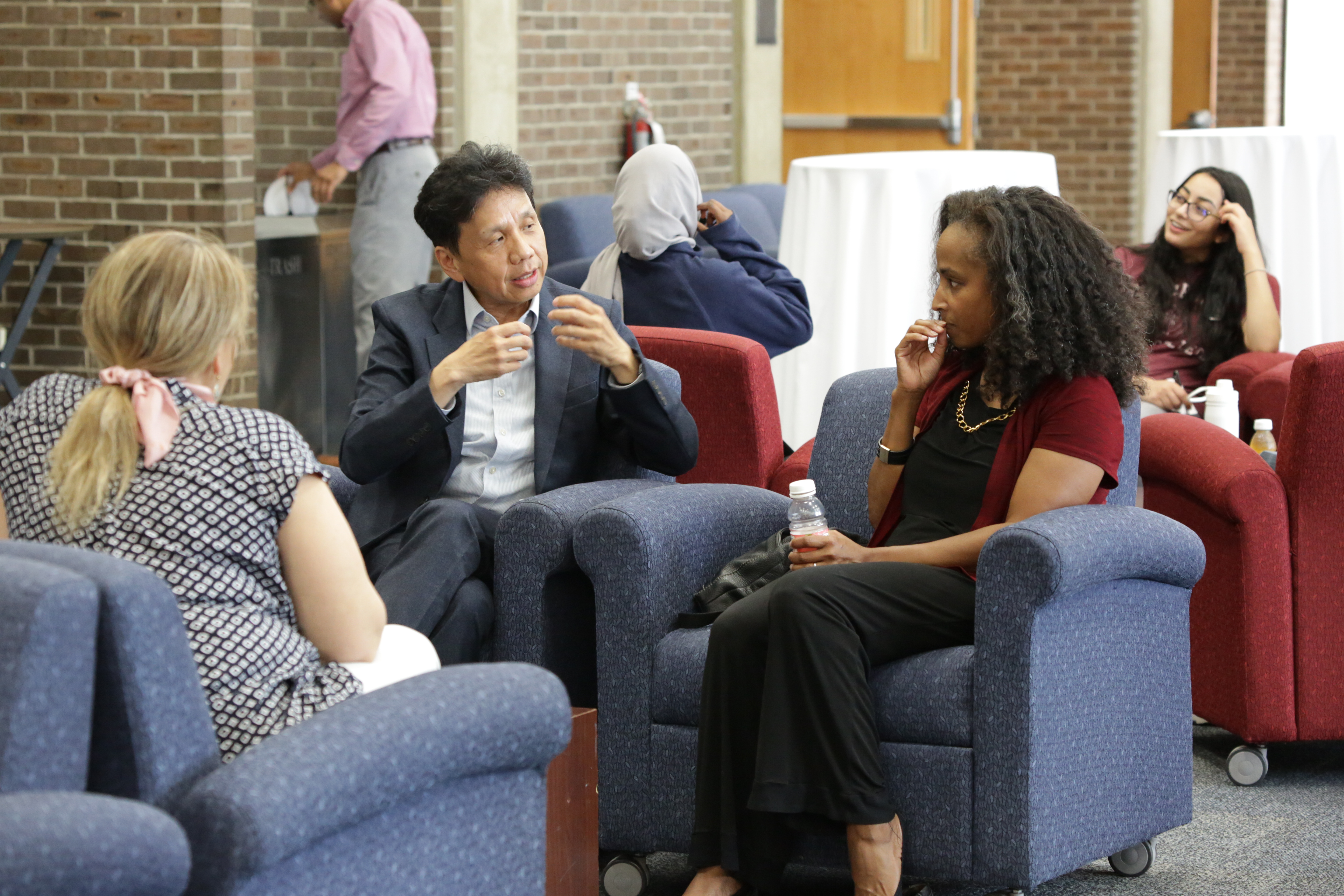 people sitting in chairs and talking