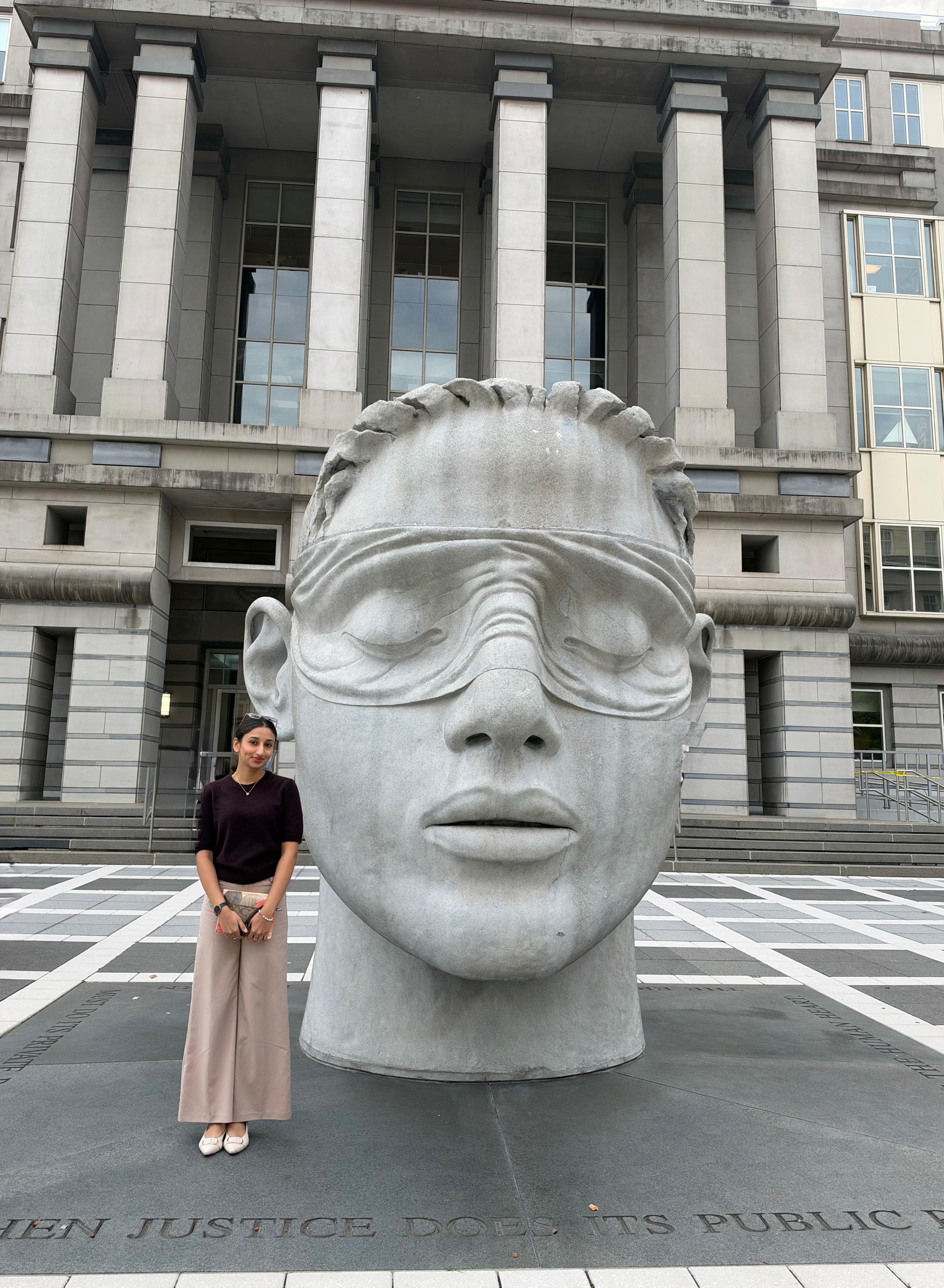 Picture of a girl posing with a big statue on the field trip
