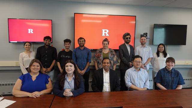 A group of students and faculty smiling for the camera 