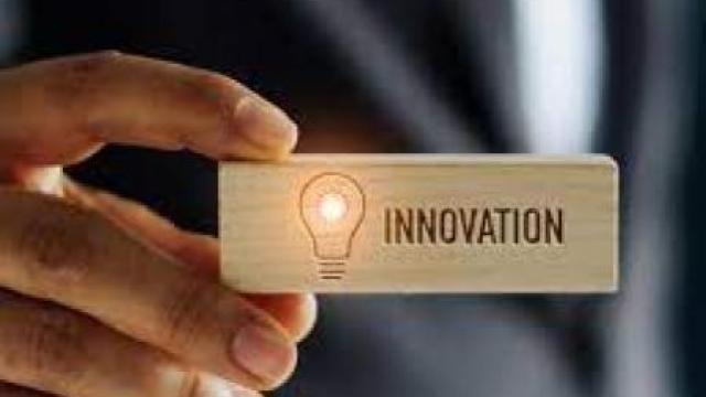 Hand holding a tile that says "innovation"