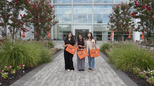 three women standing in front of building