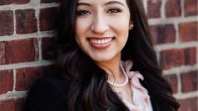 Professional headshot of MBS alumni against a brick background