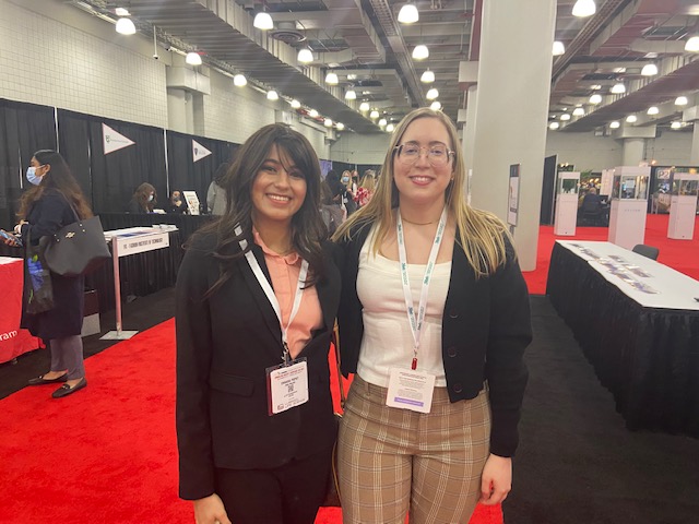 two women at a convention center gathering