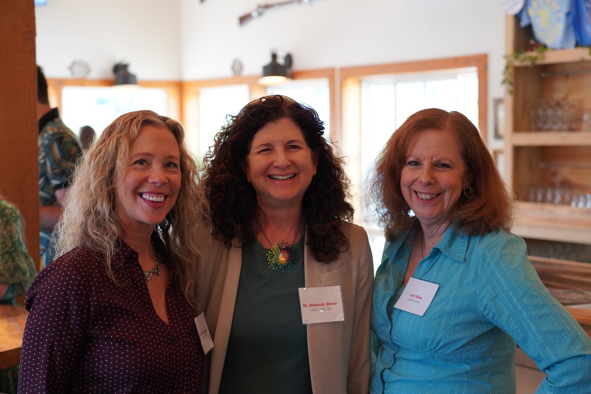 Three women pose for photo