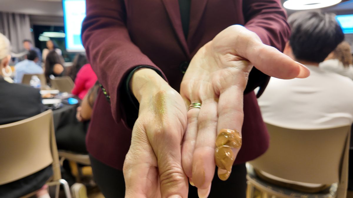 An Image of a woman's hand with a skin product