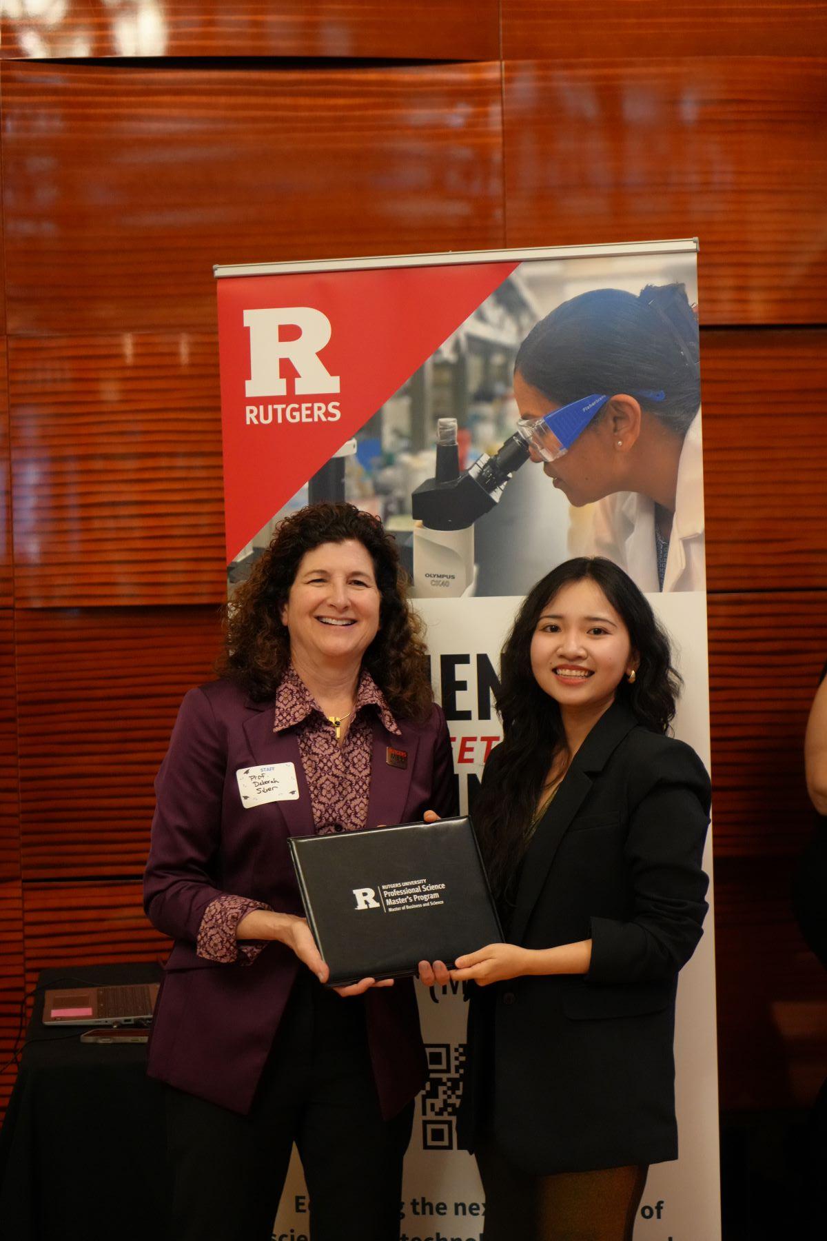 director handing certificate to student