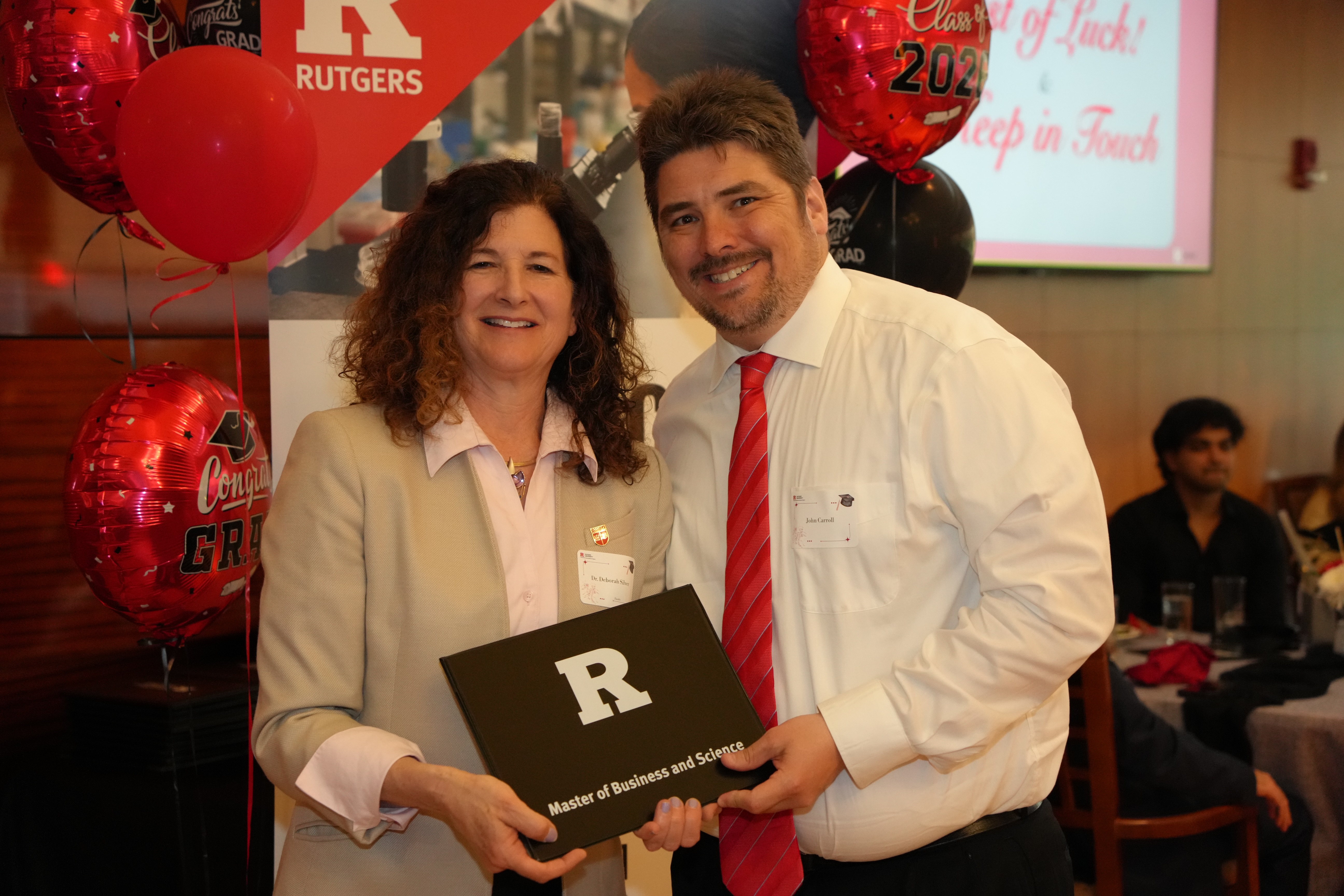 woman handing certificate to man