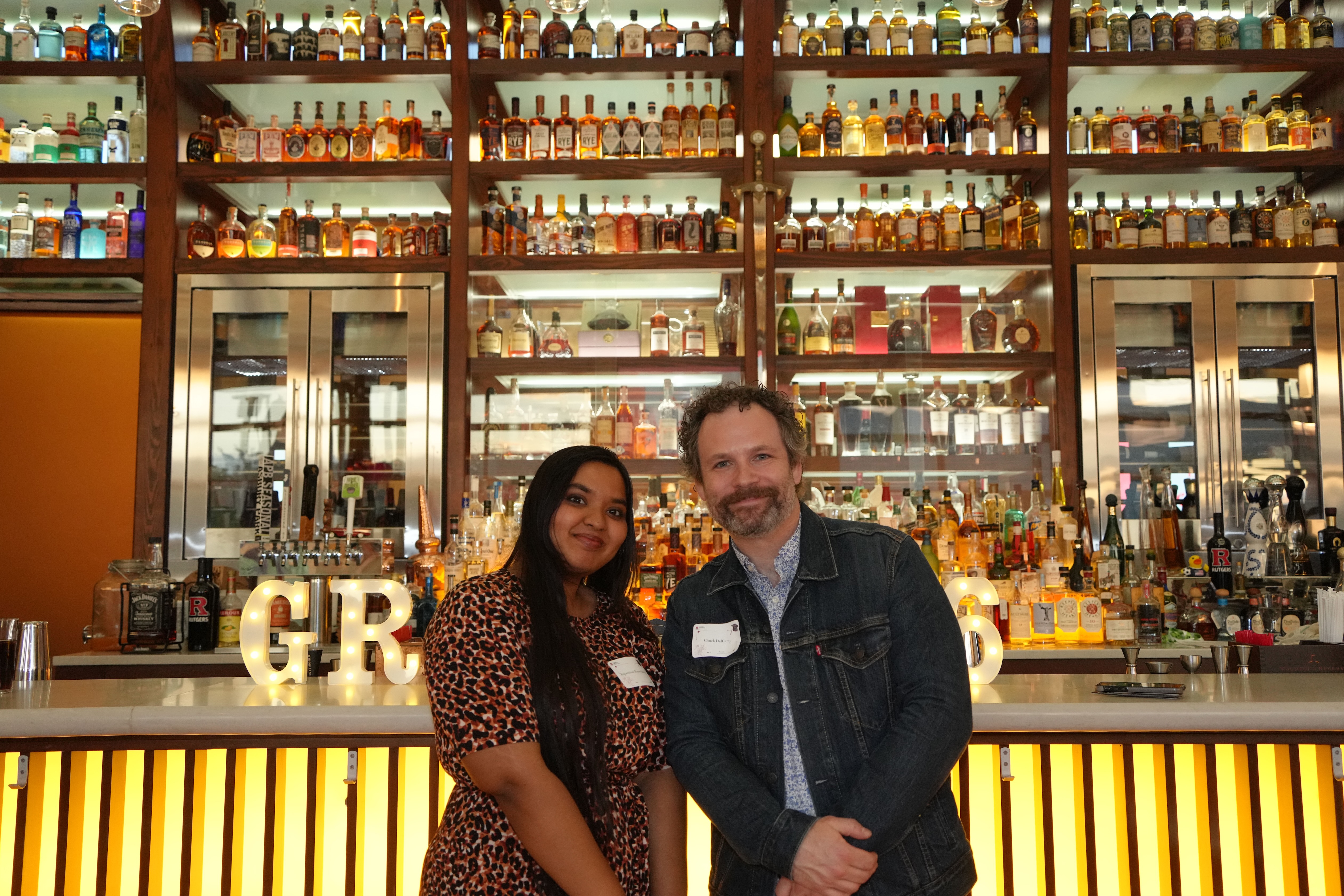 two people posing at bar