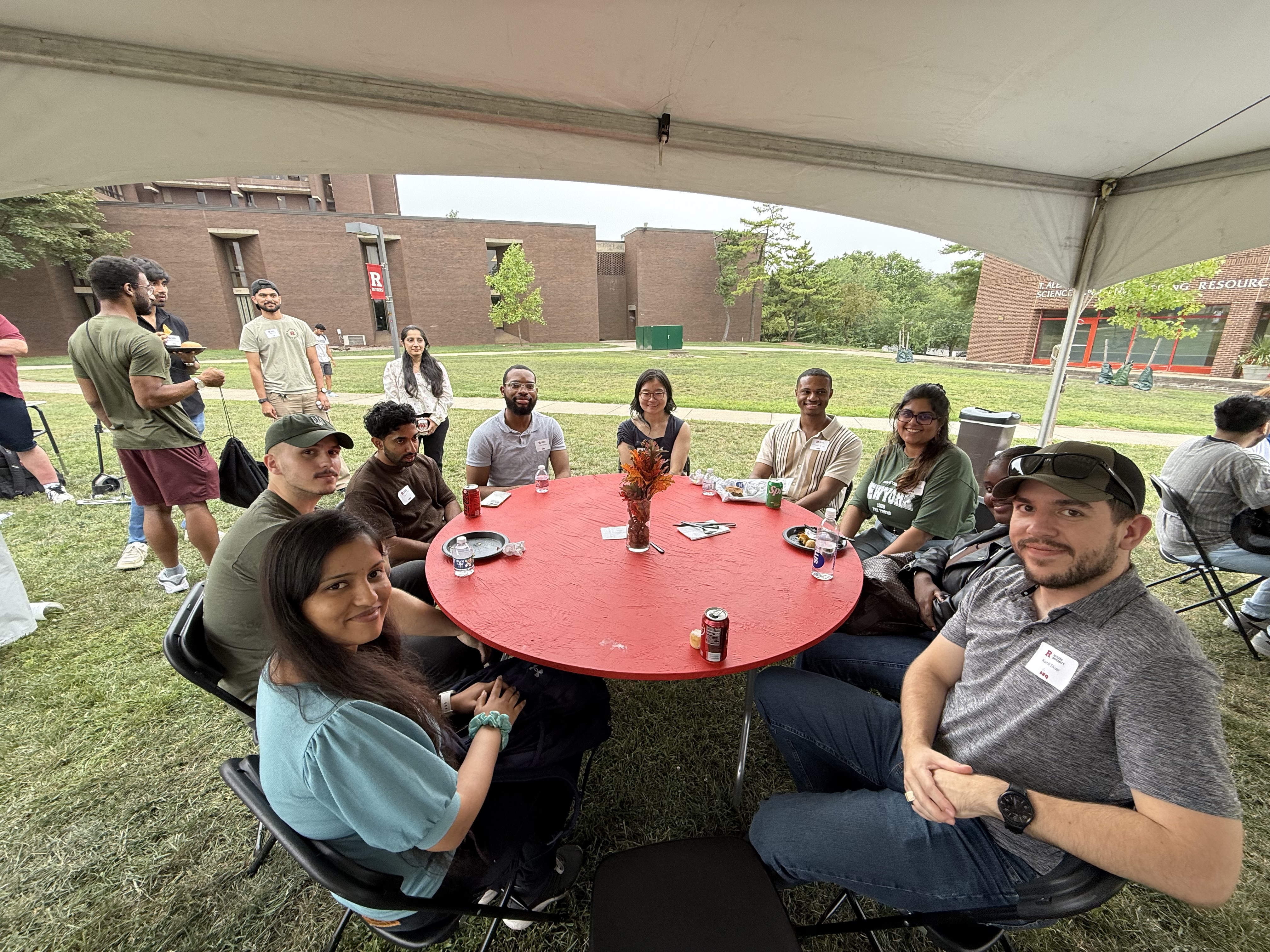 a table of students smiling at camera