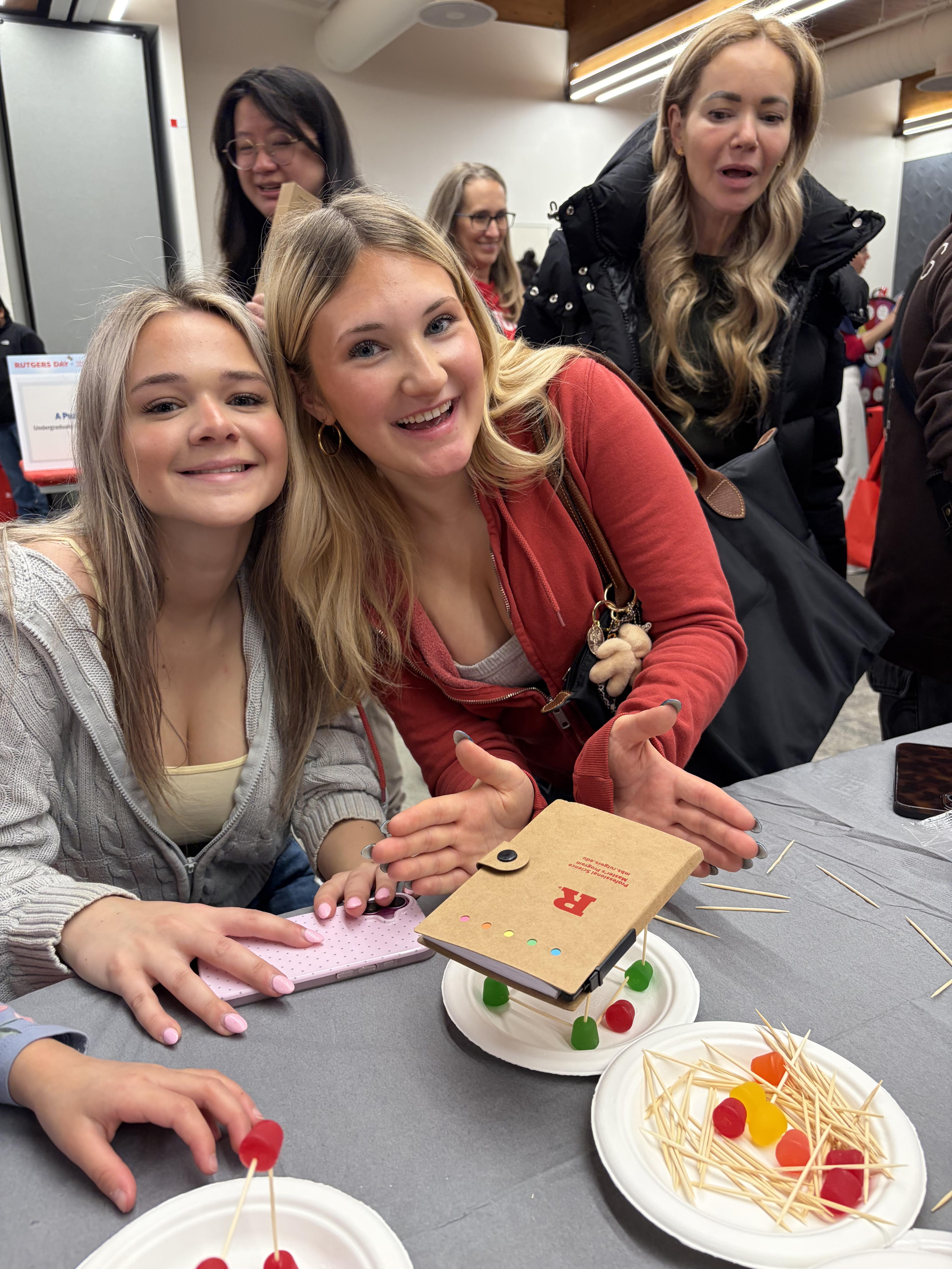 Two girls smiling and holding a diary