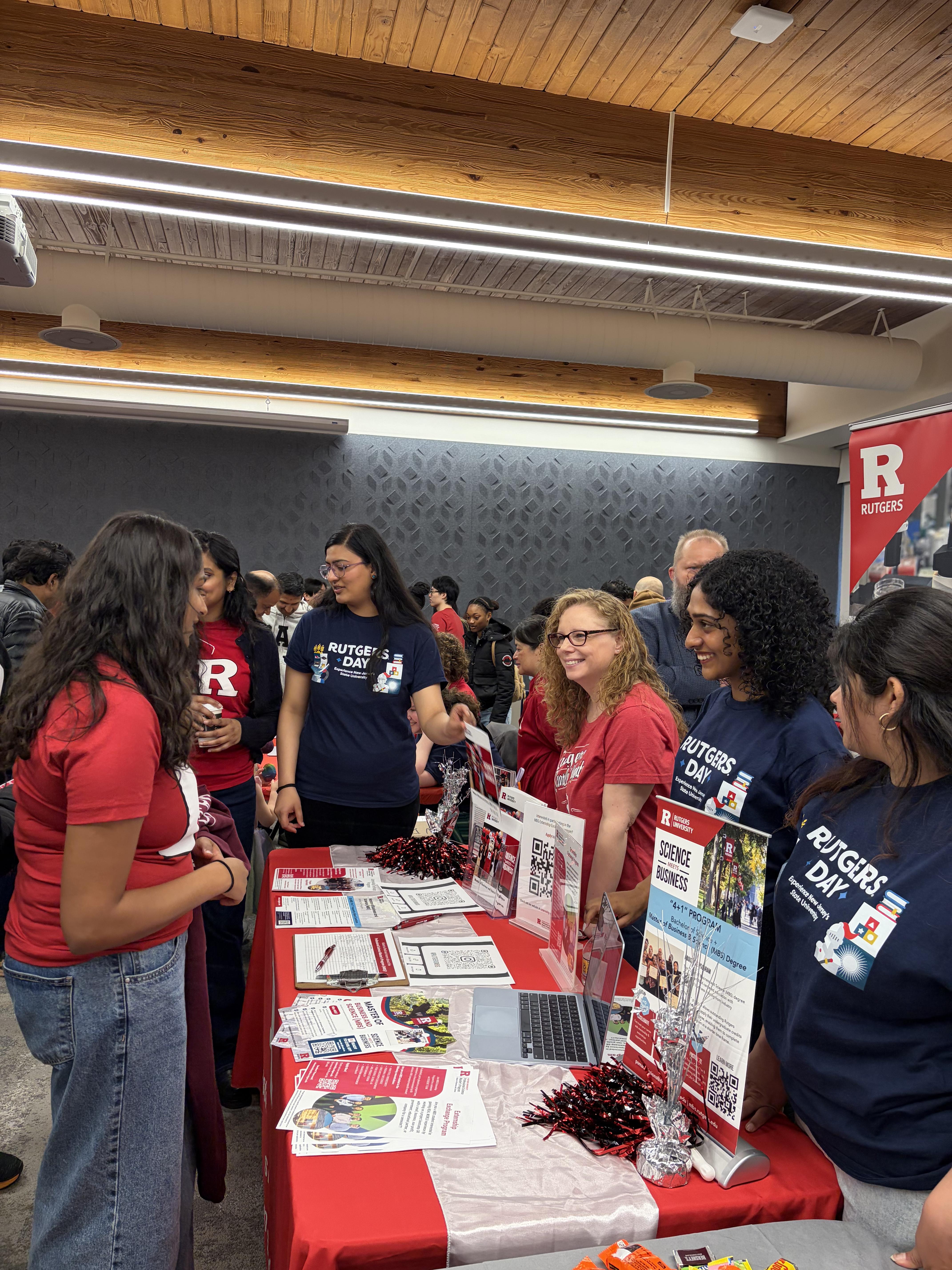 A girl interacting with people at a booth 