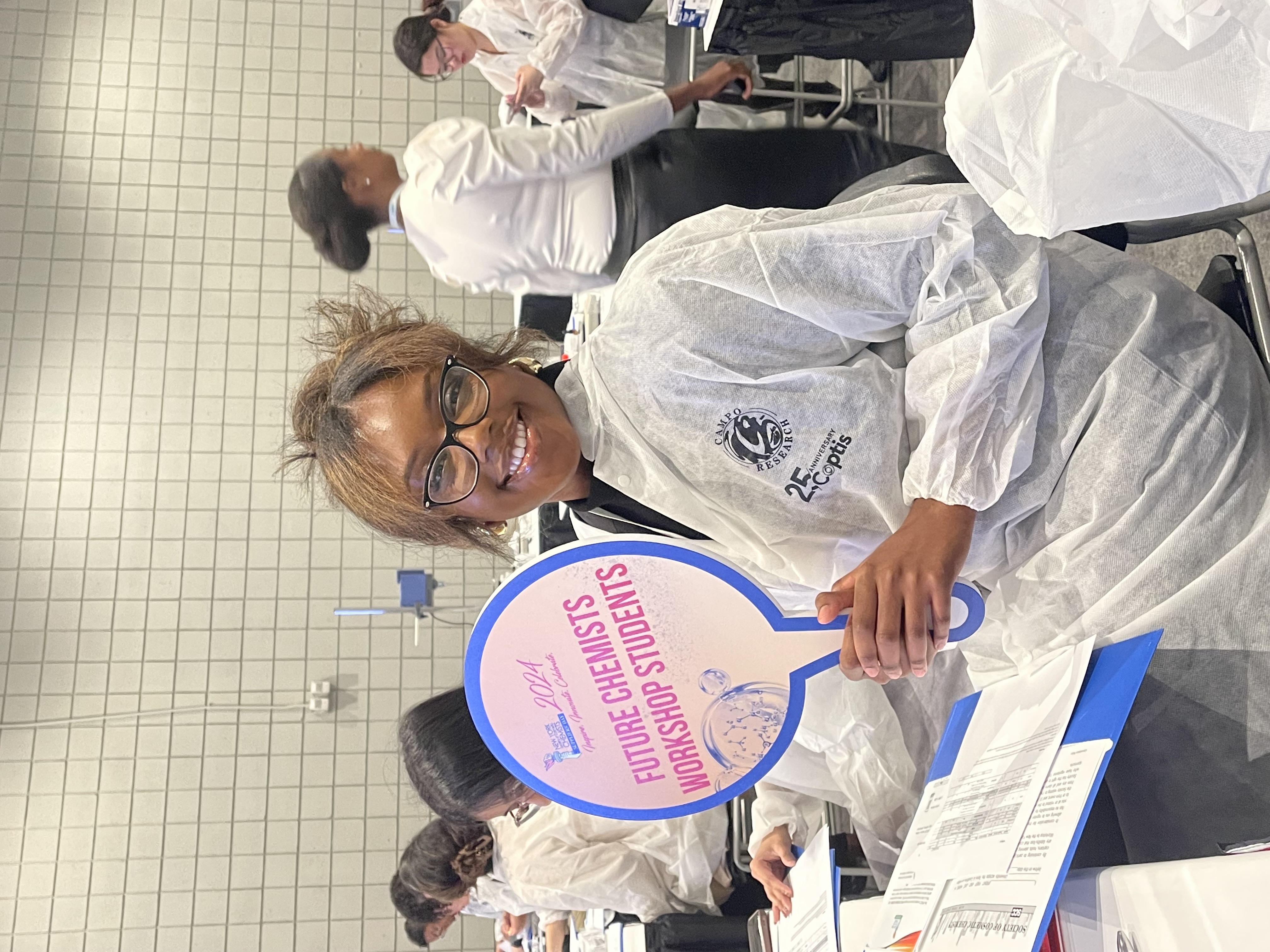 woman in lab coat smiling