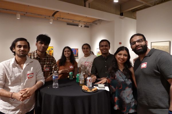 A group of people at a table having food and conversations