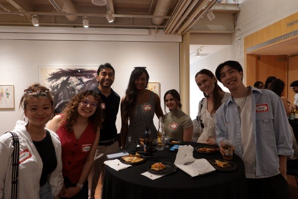 A group of people at a table having food and conversations
