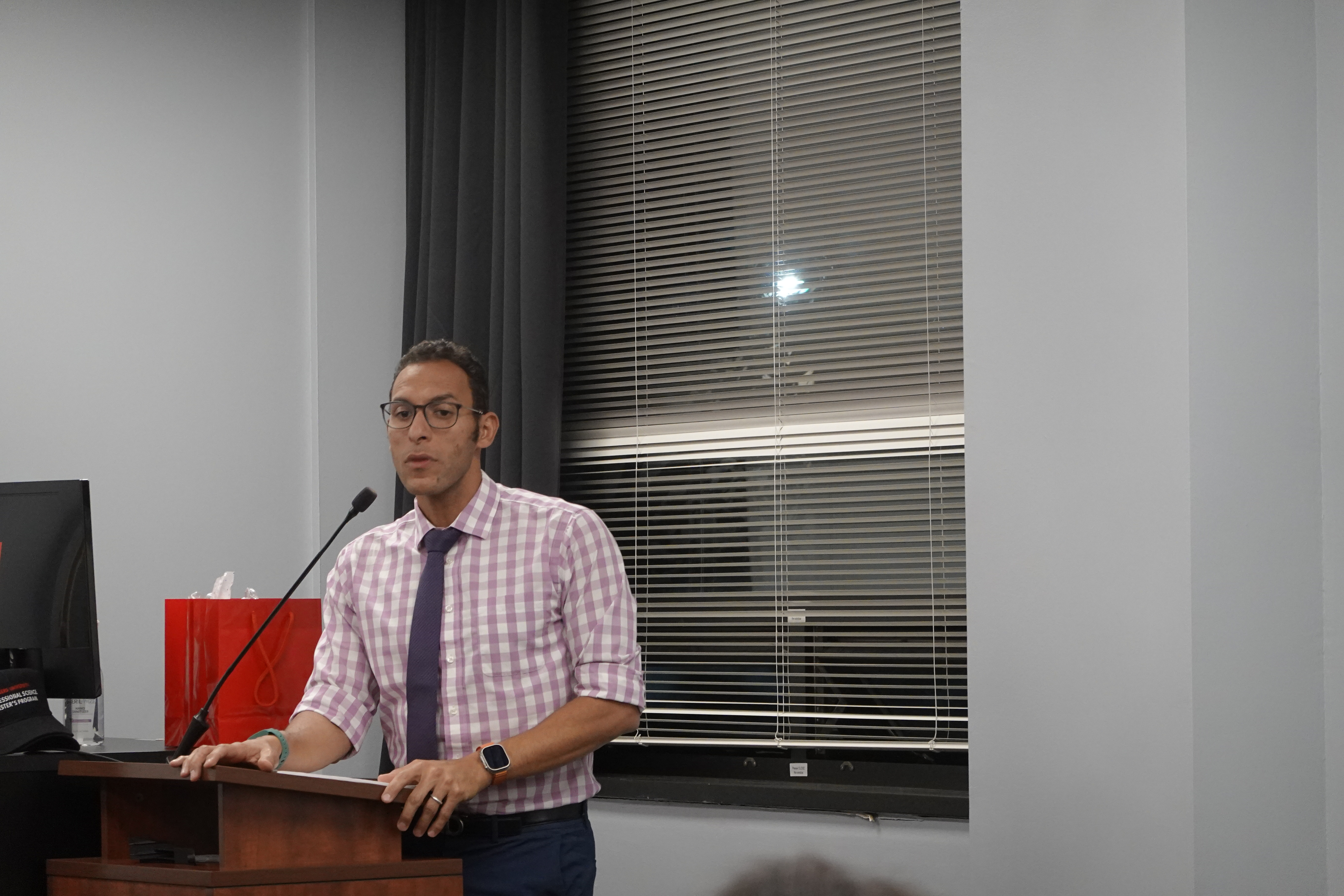 A man on podium speaking