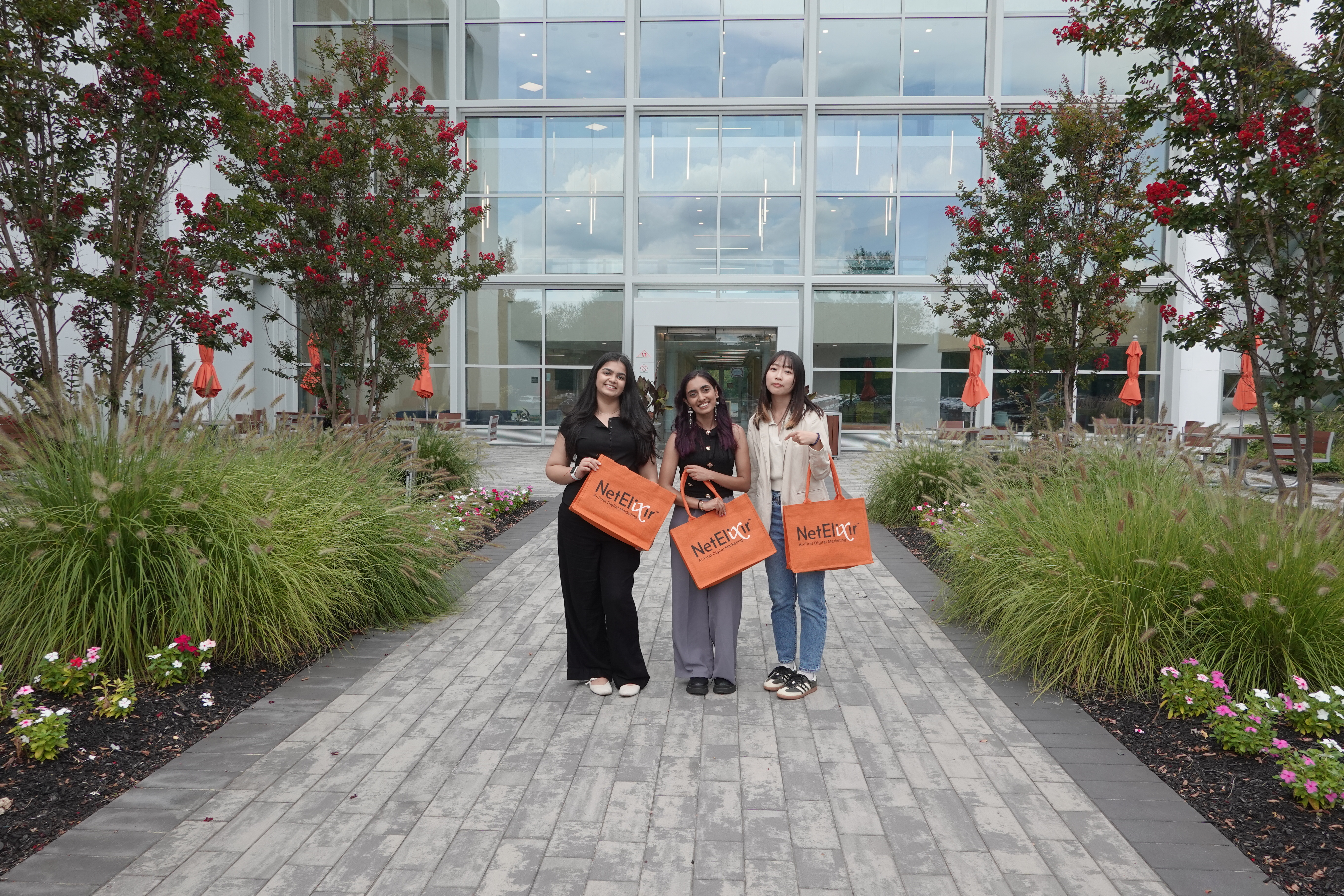 three women standing in front of building