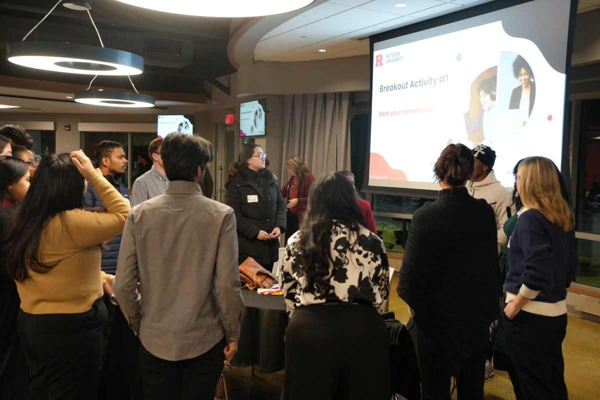 A group of students facing the big screen 