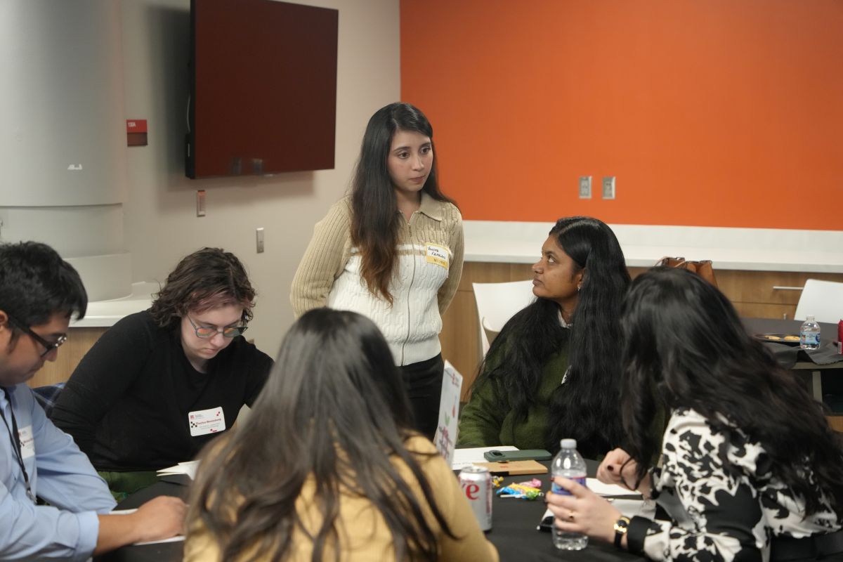 A student supervising a small group of students and their discussions