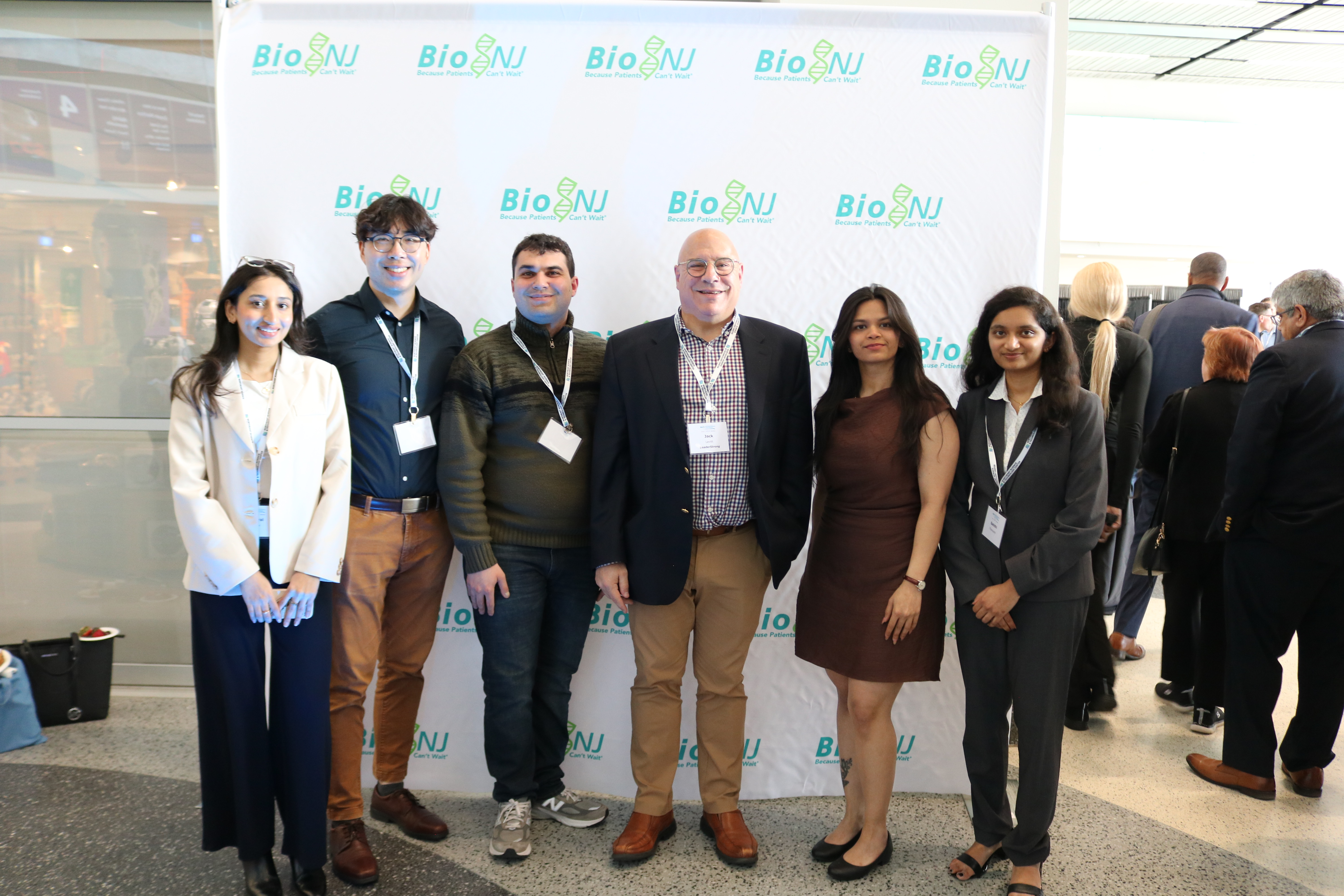 A group of students with their professor at a conference