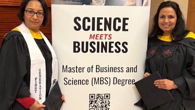 students standing next to banner